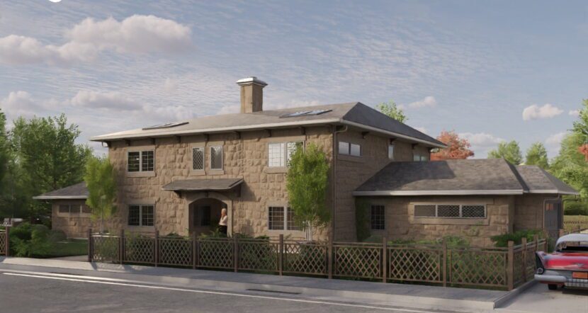 Two-storey stone-clad prefab home with chimney and lattice fence
